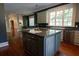 Large kitchen island with granite countertops and a sink adds functionality to this open and well-lit space at 4790 Shallowford Rd, Roswell, GA 30075
