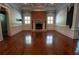 Inviting living room featuring a brick fireplace, classic wainscoting, and abundant natural light at 4790 Shallowford Rd, Roswell, GA 30075