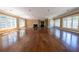 Expansive living area with hardwood floors, a fireplace, and large windows providing plenty of natural light at 4790 Shallowford Rd, Roswell, GA 30075