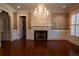 Traditional living room with hardwood floors, a fireplace, decorative wallpaper, and a chandelier at 4790 Shallowford Rd, Roswell, GA 30075