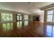 Bright and spacious living room with hardwood floors, large windows, and elegant French doors at 4790 Shallowford Rd, Roswell, GA 30075