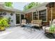 Comfortable back porch with plush seating, brick accents, potted plants, and inviting decor at 6505 Whispering Ln, Atlanta, GA 30328