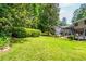 Lush backyard features a well-maintained lawn and mature trees at 6505 Whispering Ln, Atlanta, GA 30328