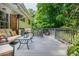 Comfortable back porch with plush seating, brick accents, and lush greenery at 6505 Whispering Ln, Atlanta, GA 30328