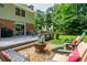 Relaxing backyard with spacious deck, stone fire pit, outdoor seating, and beautiful landscaping at 6505 Whispering Ln, Atlanta, GA 30328