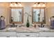 Bathroom featuring a granite countertop with double sinks, framed mirrors and modern fixtures at 6505 Whispering Ln, Atlanta, GA 30328