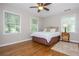 Bright bedroom with hardwood floors, dual windows, and a ceiling fan at 6505 Whispering Ln, Atlanta, GA 30328
