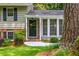 Inviting front entry showcasing a charming door, well-maintained lawn, and lush landscaping at 6505 Whispering Ln, Atlanta, GA 30328