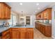 Well-lit kitchen features granite counters, wood cabinets, tile flooring, and stainless steel appliances at 6505 Whispering Ln, Atlanta, GA 30328