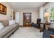 Cozy living room showcases hardwood floors, neutral paint, and lots of natural light at 6505 Whispering Ln, Atlanta, GA 30328