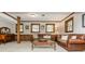 Cozy living room with a leather sofa, wood trim and large windows offering plenty of natural light at 6505 Whispering Ln, Atlanta, GA 30328