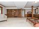 Large living room featuring a wooden bookcase and wet bar, offering ample storage and space for entertaining at 6505 Whispering Ln, Atlanta, GA 30328