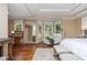 Spacious main bedroom with hardwood floors, a sitting area, and lots of windows at 6505 Whispering Ln, Atlanta, GA 30328