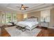 Bright main bedroom with hardwood floors, tray ceilings, and a sitting area with lots of windows at 6505 Whispering Ln, Atlanta, GA 30328