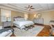 Main bedroom with hardwood floors, tray ceilings, and a comfortable king size bed at 6505 Whispering Ln, Atlanta, GA 30328