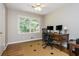 Bright office with a wooden desk, multiple monitors, and a large window with natural light at 6505 Whispering Ln, Atlanta, GA 30328