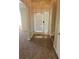View of the entryway with carpeted floor and glass front door with sidelights at 1752 Spring Hill Cv, Lithonia, GA 30058