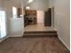 Living room featuring carpeted flooring and view of the kitchen in the back at 1752 Spring Hill Cv, Lithonia, GA 30058
