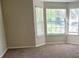 Open-concept living room features large windows and plush carpeting at 1752 Spring Hill Cv, Lithonia, GA 30058