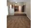 Living room featuring carpeted flooring and view of the kitchen in the back at 1752 Spring Hill Cv, Lithonia, GA 30058