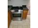 Gas range stainless steel appliance in the kitchen with tile flooring at 1752 Spring Hill Cv, Lithonia, GA 30058