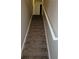 Carpeted stairway with white railing leading to upper level at 1752 Spring Hill Cv, Lithonia, GA 30058