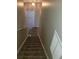 Carpeted staircase in a home with neutral colored walls and ceilings at 1752 Spring Hill Cv, Lithonia, GA 30058