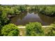 Stunning aerial view of a serene lake surrounded by lush greenery and trees at 2324 Littlebrooke Ln, Dunwoody, GA 30338