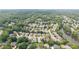 Aerial view of neighborhood homes surrounded by trees and adjacent to a lake at 2324 Littlebrooke Ln, Dunwoody, GA 30338