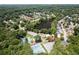 Community aerial view showcasing a lake, tennis courts and pool, with the home's location marked with a red pin at 2324 Littlebrooke Ln, Dunwoody, GA 30338