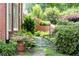 Beautiful backyard garden featuring a stone path, brick wall, and lush greenery at 2324 Littlebrooke Ln, Dunwoody, GA 30338