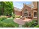 Expansive backyard featuring a brick patio, lush landscaping, and mature trees at 2324 Littlebrooke Ln, Dunwoody, GA 30338