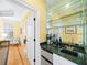 Wet bar with sink, under-counter fridge, shelving with wine glasses, marble counter, and access to other rooms at 2324 Littlebrooke Ln, Dunwoody, GA 30338