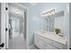 Bright bathroom featuring a sink, large mirror, and a separate shower room and toilet area at 2324 Littlebrooke Ln, Dunwoody, GA 30338