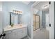 Bright bathroom featuring a sink, large mirror, and a separate shower room and toilet area at 2324 Littlebrooke Ln, Dunwoody, GA 30338