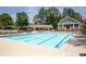 Community pool and clubhouse area surrounded by lounge chairs and trees at 2324 Littlebrooke Ln, Dunwoody, GA 30338