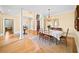 Elegant dining room featuring hardwood floors, decorative columns, chandelier, and space for a large dining table at 2324 Littlebrooke Ln, Dunwoody, GA 30338