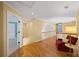 Bright hallway with hardwood floors, chair, and multiple doorways leading to other rooms at 2324 Littlebrooke Ln, Dunwoody, GA 30338