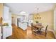Eat-in kitchen with bright white cabinets, stainless appliances, a center island, and hardwood floors at 2324 Littlebrooke Ln, Dunwoody, GA 30338