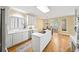 Bright kitchen with white cabinets, central island, hardwood floors, and ample natural light from a large window at 2324 Littlebrooke Ln, Dunwoody, GA 30338