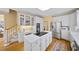 Modern kitchen with white cabinetry, stainless steel appliances, a central island, and hardwood flooring at 2324 Littlebrooke Ln, Dunwoody, GA 30338