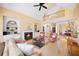 Spacious living room with vaulted ceilings, a cozy fireplace, built-in bookcases, and a large window with backyard views at 2324 Littlebrooke Ln, Dunwoody, GA 30338