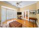 Bright living room with hardwood floors, ottoman, white trim, and three-section window with plantation shutters at 2324 Littlebrooke Ln, Dunwoody, GA 30338