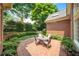 Charming brick patio with outdoor seating surrounded by lush landscaping at 2324 Littlebrooke Ln, Dunwoody, GA 30338