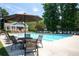 Sparkling community pool with a lifeguard stand, surrounded by lounge chairs, and adjacent to a charming clubhouse at 2324 Littlebrooke Ln, Dunwoody, GA 30338