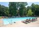 Large community pool with plenty of lounge chairs and greenery, perfect for relaxing and soaking up the sun at 2324 Littlebrooke Ln, Dunwoody, GA 30338
