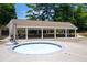 Relaxing hot tub or spa area near a covered outdoor pavilion with tables and seating, perfect for community gatherings at 2324 Littlebrooke Ln, Dunwoody, GA 30338