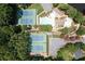 Aerial view of the tennis courts with a pool and lounge area nearby at 2324 Littlebrooke Ln, Dunwoody, GA 30338