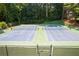 Well-maintained tennis courts surrounded by lush greenery, offering a great recreational amenity for residents at 2324 Littlebrooke Ln, Dunwoody, GA 30338