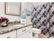 Well-lit bathroom with granite countertop, updated vanity, and shower with curtain at 310 Medridge Dr, Alpharetta, GA 30022